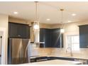 Modern kitchen with dark cabinets, quartz countertops and stainless steel appliances at 42 Summer Dr, Walterboro, SC 29488