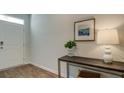 Light and bright entryway with wood flooring, console table, and lamp at 5540 Dalmore Dr, Ravenel, SC 29470