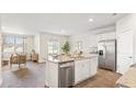 Open concept kitchen with island, stainless steel appliances, and hardwood floors at 5540 Dalmore Dr, Ravenel, SC 29470