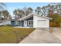 Charming blue house with white accents and a large yard at 607 Mountain Pine Road, Moncks Corner, SC 29461