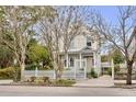 Charming yellow house with white picket fence and landscaped yard at 12 John St # Includes 8 & 10, Charleston, SC 29403
