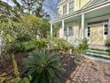 Landscaped front yard with brick walkway leading to porch at 12 John St # Includes 8 & 10, Charleston, SC 29403