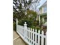 White picket fence and lush landscaping enhance curb appeal at 12 John St # Includes 8 & 10, Charleston, SC 29403