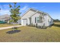 Charming new home with white siding, landscaping, and a spacious driveway at 120 Clear Tide Dr, Summerville, SC 29486