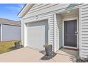Modern garage and front entry with black door and white siding at 120 Clear Tide Dr, Summerville, SC 29486