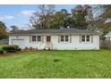 Charming ranch home with white brick exterior, landscaped lawn, and attached garage at 1349 Coosaw Dr, Charleston, SC 29407