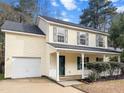 Two-story house with a front porch, attached garage, and landscaped yard at 238 Trickle Dr, Summerville, SC 29483