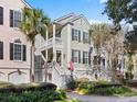 Charming three-story home with a front porch and landscaped yard at 2434 Racquet Club Dr, Seabrook Island, SC 29455