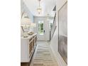 Bright entryway with built-in storage, light wood floors, and an elegant chandelier at 484 Queenview Ln, Charleston, SC 29414