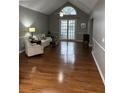 Living room with hardwood floors, a beige couch and a large window at 9049 Delancey Cir, North Charleston, SC 29406