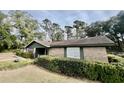 Brick ranch house with green trim, situated on a spacious lot with mature trees at 208 Howard St, Varnville, SC 29944