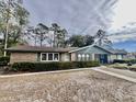 Ranch style home with a brick facade and lush landscaping at 208 Howard St, Varnville, SC 29944