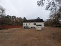 Home's rear view, showing a deck, fenced yard, and storage shed at 268 Homer Dr, Cross, SC 29436