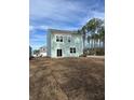 Back of house showing a large yard and light teal siding at 3005 Dalmore Dr, Ravenel, SC 29470