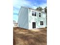 Rear view of a light teal two-story house with a patio at 3005 Dalmore Dr, Ravenel, SC 29470