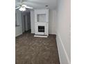 Living room with fireplace and brown carpet at 3930 Azalea Dr # W, North Charleston, SC 29405