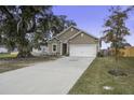 House with a two car garage and a large oak tree in the front at 435 Eva St, Moncks Corner, SC 29461