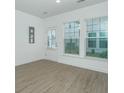 Spacious living room featuring hardwood floors and multiple windows at 7104 Channel Park Dr, Hanahan, SC 29410