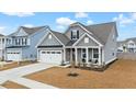 Gray two-story house with white garage door and front porch at 655 Black Pine Rd, Moncks Corner, SC 29461