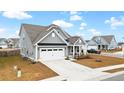 Gray two-story house with white garage door and side yard at 655 Black Pine Rd, Moncks Corner, SC 29461