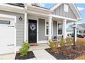 Black front door with wreath and rocking chairs on porch at 655 Black Pine Rd, Moncks Corner, SC 29461