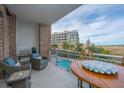 Private balcony with outdoor furniture, overlooking a pool and marsh at 155 Wingo Way # 424, Mount Pleasant, SC 29464