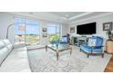 Living room with white leather couch, blue armchairs, and marsh views at 155 Wingo Way # 424, Mount Pleasant, SC 29464