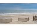 Oceanfront view with sandy beach and dune fencing at 1579 E Ashley Ave, Folly Beach, SC 29439