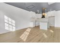 Modern kitchen with white cabinets, quartz countertops, and a statement range hood at 194 Nassau St, Charleston, SC 29403