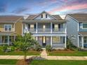 Two-story house with gray siding, a balcony, and a well-manicured lawn at 205 Oak View Way, Summerville, SC 29483