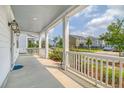 Inviting front porch with white railings and elegant lanterns at 205 Oak View Way, Summerville, SC 29483