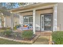Charming front porch with a white swing and landscaping at 240 Mayfield Dr, Goose Creek, SC 29445