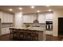 Modern kitchen with white cabinets, large island, and stainless steel appliances at 219 Darby Meadow Ln, Ridgeville, SC 29472