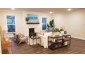 Bright living room featuring a fireplace and ample natural light at 219 Darby Meadow Ln, Ridgeville, SC 29472