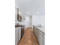 Modern kitchen with gray cabinets, granite counters, and stainless steel appliances at 252 Watersglen Way, Summerville, SC 29486