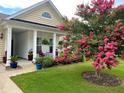 Landscaped front yard with blooming crape myrtle and colorful flowerbeds at 506 Tranquil Waters Way, Summerville, SC 29486