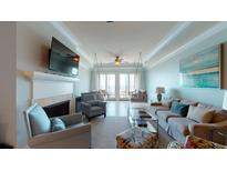 Bright living room with ocean view, fireplace and comfortable seating at 113 E Arctic Ave # B, Folly Beach, SC 29439