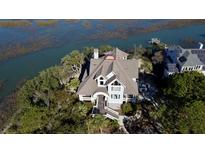 Luxury waterfront home with expansive roofline and private dock at 268 Little Oak Island Dr, Folly Beach, SC 29439