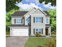 Two-story home with gray siding, white garage door, and landscaping at 15 Darby Meadow Ln, Ridgeville, SC 29472