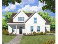 White farmhouse with a charming front porch and landscaping at 40 Waycross Dr, Ridgeville, SC 29472