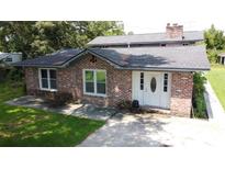 Brick ranch house with gray roof, white door, and landscaped yard at 114 Berkeley Cir, Summerville, SC 29483