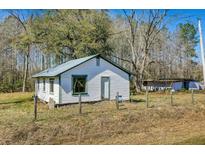 White house with green trim, situated on a grassy lot with trees in the background at 0 Gum Branch Rd, Saint George, SC 29477