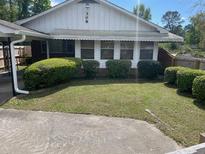 House exterior features a well-maintained front yard with bushes at 308 N Live Oak Dr, Moncks Corner, SC 29461
