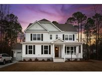 Two-story white house at dusk at 2042 Bullyard Sound Way, Awendaw, SC 29429