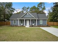Charming gray house with a white front door and a spacious yard at 309 Meadow St, Walterboro, SC 29488