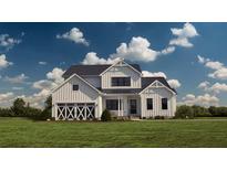 Two-story farmhouse with white siding, a dark roof, and a three-car garage at 639 Faulkner Dr, Mount Pleasant, SC 29466