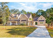 Stunning brick home with metal roof, landscaped yard, and porte-cochère at 3820 Gnarled Oaks Ln, Johns Island, SC 29455