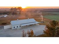 Aerial view of a modern farmhouse with expansive acreage at 6500 Parkers Ferry Rd, Adams Run, SC 29426