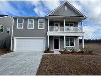 Two story home with attached garage and front porch at 320 Blue Oak Dr, Moncks Corner, SC 29461