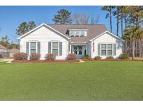 White two-story house with gray shutters and a landscaped yard at 424 Bowstring Dr, Huger, SC 29450